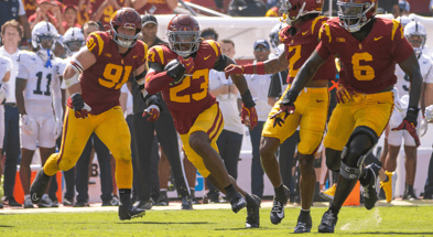 USC linebacker Desman Stephens returns an interception behind blocking from his teammates during a game against Penn State