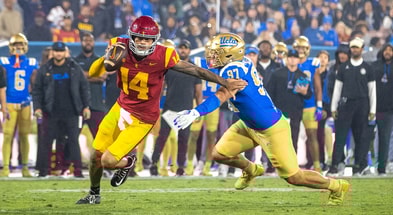 USC quarterback Jayden Maiava scrambles away from a UCLA defender
