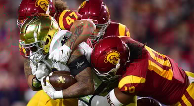 Notre Dame Fighting Irish wide receiver Avery Davis (3) is brought down by USC Trojans defensive lineman Stanley Ta'ufo'ou (47) and linebacker Ralen Goforth (10) during the first half at the Los Angeles Memorial Coliseum