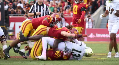 USC defenders finish off a tackle of Notre Dame quarterback Riley Leonard during a game between the Trojans and Fighting Irish