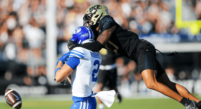 Central Florida Knights cornerback Chasen Johnson (27) is flagged for pass interference against Brigham Young Cougars wide receiver Chase Roberts (2) in the first half at FBC Mortgage Stadium