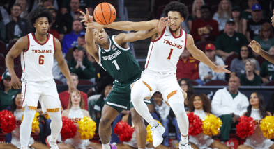 USC Trojans guard Desmond Claude (1) battles Michigan State Spartans guard Jeremy Fears Jr. (1) for control of the ball during the first half at Galen Center
