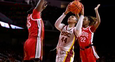 USC Trojans forward Kiki Iriafen (44) shoots between Ohio State Buckeyes forward Eboni Walker (55) and Ohio State Buckeyes guard Jaloni Cambridge (22) during the third quarter at Galen Center