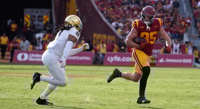 USC Trojans tight end Walker Lyons (85) carries the ball against Notre Dame Fighting Irish safety Xavier Watts (0) in the second half at United Airlines Field at Los Angeles Memorial Coliseum