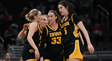 The Hawkeyes huddle during a game against Michigan State at the Big Ten Tournament. (Photo by Dennis Scheidt)