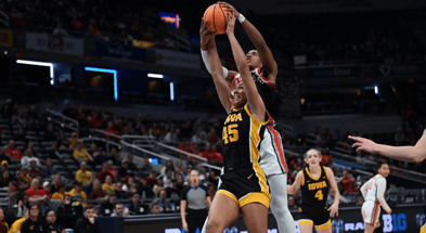 Iowa forward Hannah Stuelke rebounds against Ohio State at the Big Ten Tournament. (Photo by Dennis Scheidt)