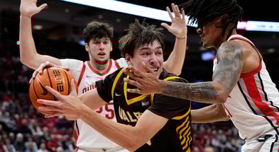 Ohio State Buckeyes forward Devin Royal (21) defends Valparaiso Beacons forward Cooper Schwieger (13) during the during the first half of the NCAA men's basketball game at Value City Arena in Columbus on Dec. 17, 2024.