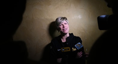 Iowa head coach Jan Jensen speaks with the media at the Selection Sunday watch party. (Photo by Dennis Scheidt)