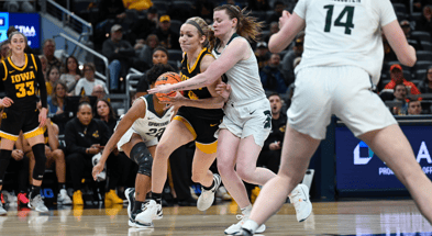 Iowa guard Kylie Feuerbach drives to the basket against Michigan State at the Big Ten Tournament. (Photo by Dennis Scheidt)