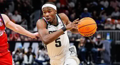 Michigan State guard Tre Holloman (5) dribbles against Ole Miss guard Sean Pedulla (3) during the second half of the Sweet 16 round of NCAA tournament at State Farm Arena in Atlanta, Ga. - Junfu Han, USA TODAY Sports