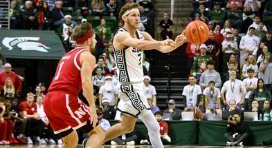 Michigan State Spartans guard Gehrig Normand (7) passes to a teammate in front of Nebraska Cornhuskers guard Sam Hoiberg (1) during the second half at Jack Breslin Student Events Center. - Dale Young, USA TODAY Sports