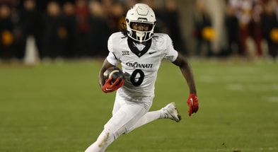 Nov 16, 2024; Ames, Iowa, USA; Cincinnati Bearcats wide receiver Tony Johnson (0) runs for a first down against the Iowa State Cyclones in the second half at Jack Trice Stadium. The Iowa State Cyclones won the game 34-17. Mandatory Credit: Reese Strickland-Imagn Images