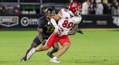 Utah Utes wide receiver Zacharyus Williams (89) catches a pass as UCF Knights defensive back Ladarius Tennison (13) moves in during the second half at FBC Mortgage Stadium