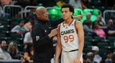 Feb 1, 2025; Coral Gables, Florida, USA; Miami Hurricanes interim head coach Bill Courtney talks to guard Divine Ugochukwu (99) during the first half against the Notre Dame Fighting Irish at Watsco Center. Mandatory Credit: Sam Navarro-Imagn Images