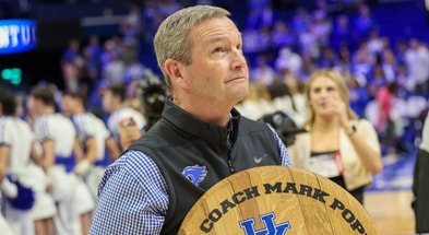 Kentucky athletic director Mitch Barnhart holds a commemorative bourbon barrel top following Mark Pope's first win as head coach - Mont Dawson, Kentucky Sports Radio