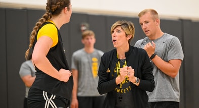 Head coach Jan Jensen instructs freshman center Layla Hays. (Photo by Dennis Scheidt)