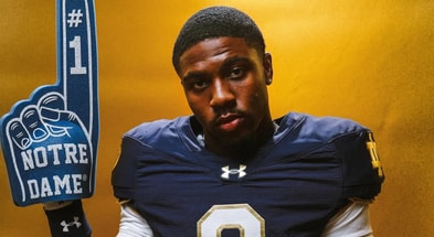 Brayden Robinson poses with a foam finger during a photoshoot on his Notre Dame official visit