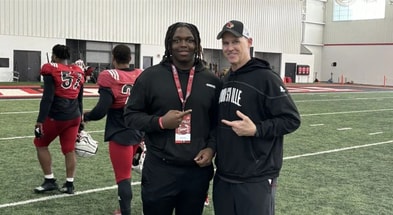 Josiah Hope and Louisville DL coach Mark Hagen on a visit