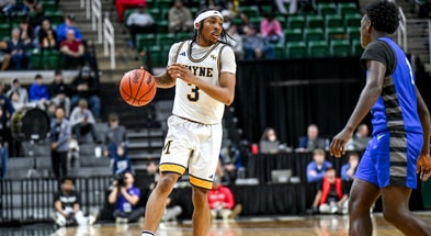 Wayne Memorial guard and Michigan State commit Carlos Medlock Jr. moves the ball against Flint Carman-Ainsworth during the second quarter in the Division 1 state semifinal on Friday, March 14, 2025. - Nick King, USA TODAY Sports