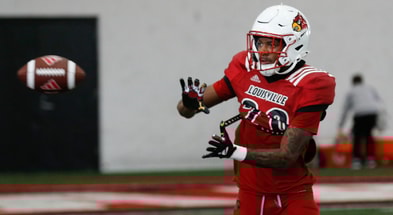 Louisville’s Tayon Holloway (20) catches the ball during Spring Practice on Thursday. April 4, 2024