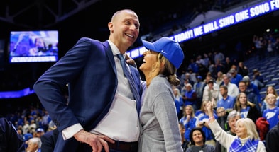 Nov 29, 2024; Lexington, Kentucky, USA; Kentucky Wildcats head coach Mark Pope talks with his wife Lee Anne after the game against the Georgia State Panthers at Rupp Arena at Central Bank Center. Mandatory Credit: Jordan Prather-Imagn Images