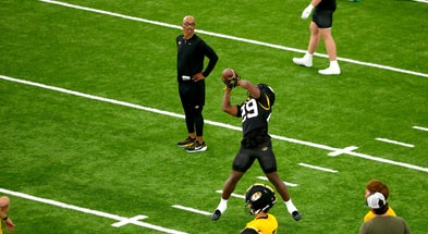 Missouri running backs coach Curtis Luper (back) watches running back Ahmad Hardy (29) catch a pass during fall camp