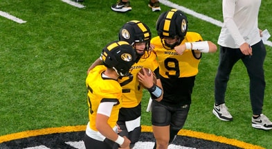 Beau Pribula (9) and Matt Zollers (5) try to punch the ball away from Sam Horn (21)