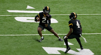 Marquis Johnson jukes past James Madison during a drill