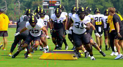 Marquis Gracial (33) and Daeden Hopkins (93) lead a line in warmups