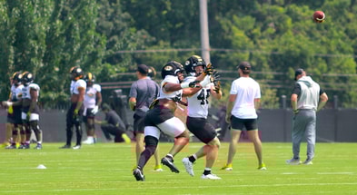 Josiah Trotter (left) and Jackson Daily (right) fight for a ball during a drill