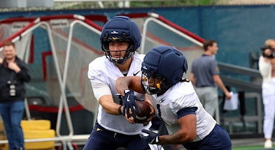 West Virginia quarterback Nicco Marchiol handsoffs to running back Jahiem White during fall practice