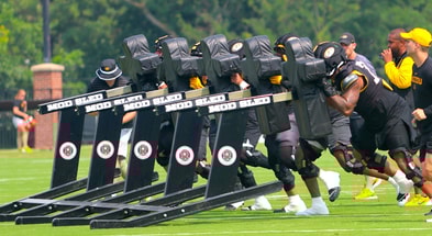 Mizzou offensive linemen push a blocking sled