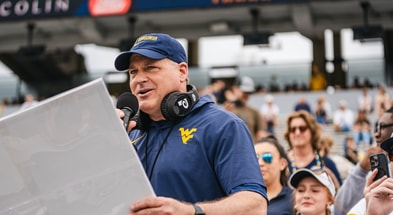 West Virginia head coach Rich Rodriguez calling plays during practice