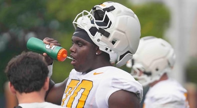 Caitie McMekin/News Sentinel / USA TODAY NETWORK via Imagn Images  | Tennessee offensive lineman David Sanders Jr. (70) drinks water during Tennessee football preseason practice, in Knoxville, Tennessee, July 31, 2025.