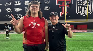 Alexander Herrera with Texas Tech head coach Joey McGuire