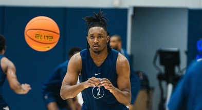 West Virginia guard Chance Moore bringing in the pass at practice