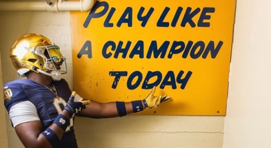 Elijah Golden with Notre Dame's Play Like A Champion Today sign.