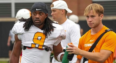 Angelina Alcantar/News Sentinel / USA TODAY NETWORK via Imagn Images | Tennessee running back Star Thomas (9) takes a water bottle from a trainer during Tennessee football preseason practice, in Knoxville, Tennessee, Aug. 6, 2025.