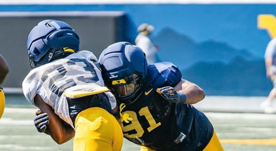 West Virginia's football players go through a preaseason scrimmage