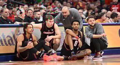 Jan 14, 2025; Syracuse, New York, USA; Louisville Cardinals assistant coaches Brian Kloman (standing) and Mike Cassidy give instructions to forward Khani Rooths (9) and guard Reyne Smith (6) and forward James Scott (0) before entering the game in the second half against the Syracuse Orange at the JMA Wireless Dome. Mandatory Credit: Mark Konezny-Imagn Images