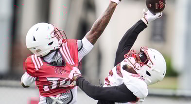 Louisville Cardinals wide receiver Caullin Lacy (5) tries to make a catch under pressure from defensive back Rae'mon Mosby (30) during a recent practice on August 4, 2025 before the start of the 2025 football season.