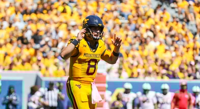 West Virginia quarterback Nicco Marchiol looks for the call from the sideline