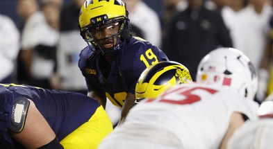 Aug 30, 2025; Ann Arbor, Michigan, USA;  Michigan Wolverines quarterback Bryce Underwood (19) gets set to run a play in the first half against the New Mexico Lobos at Michigan Stadium. Mandatory Credit: Rick Osentoski-Imagn Images