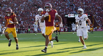 USC Trojans running back Eli Sanders (1) is pursued by Missouri State Bears safety J.J. O'Neal (16) and safety Maguire Neal (0) on a 73-yard touchdown reception in the first half at United Airlines Field at Los Angeles Memorial Coliseum