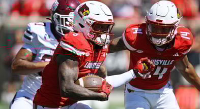 Aug 30, 2025; Louisville, Kentucky, USA; Louisville Cardinals wide receiver Caullin Lacy (5) runs the ball against Eastern Kentucky Colonels linebacker Blake Howard (37) during the first quarter at L&N Federal Credit Union Stadium. Mandatory Credit: Jamie Rhodes-Imagn Images
