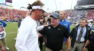 Sep 28, 2024; Oxford, Mississippi, USA; Mississippi Rebels head coach Lane Kiffin (left) and Kentucky Wildcats head coach Mark Stoops (right) embrace after the game at Vaught-Hemingway Stadium. Mandatory Credit: Petre Thomas-Imagn Images
