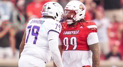 Louisville Cardinals defensive lineman Jordan Guerad (99) has words with James Madison Dukes offensive lineman Joseph Simmons (79) in the first half during the Louisville-James Madison college football game Friday September 5, 2025 at L&N Credit Union Stadium in Louisville, Kentucky.