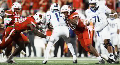 Louisville Cardinals defensive lineman Clev Lubin (50) and Louisville Cardinals defensive lineman Wesley Bailey (23) sack DUPLICATE***James Madison Dukes quarterback Alonza Barnett III (14) in the first half during the Louisville-James Madison college football game Friday September 5, 2025 at L&N Credit Union Stadium in Louisville, Kentucky.