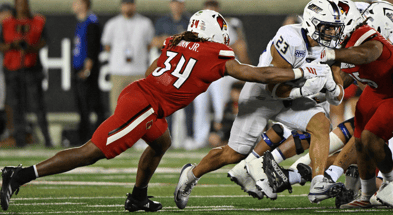 Sep 5, 2025; Louisville, Kentucky, USA; James Madison Dukes running back Jordan Fuller (23) runs the ball against Louisville Cardinals linebacker TJ Quinn (34) during the second half at L&N Federal Credit Union Stadium. Mandatory Credit: Jamie Rhodes-Imagn Images