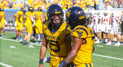 West Virginia quarterback Scotty Fox Jr. celebrates after scoring a touchdown